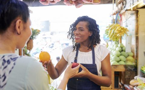 Vendor helping customer at local market